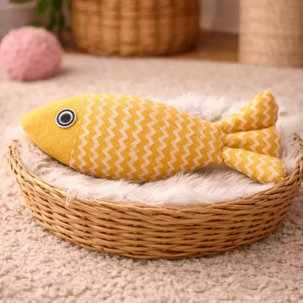 Jeu poisson pour chat Féli’Fish jaune, présenté seul en intérieur dans un panier cosy